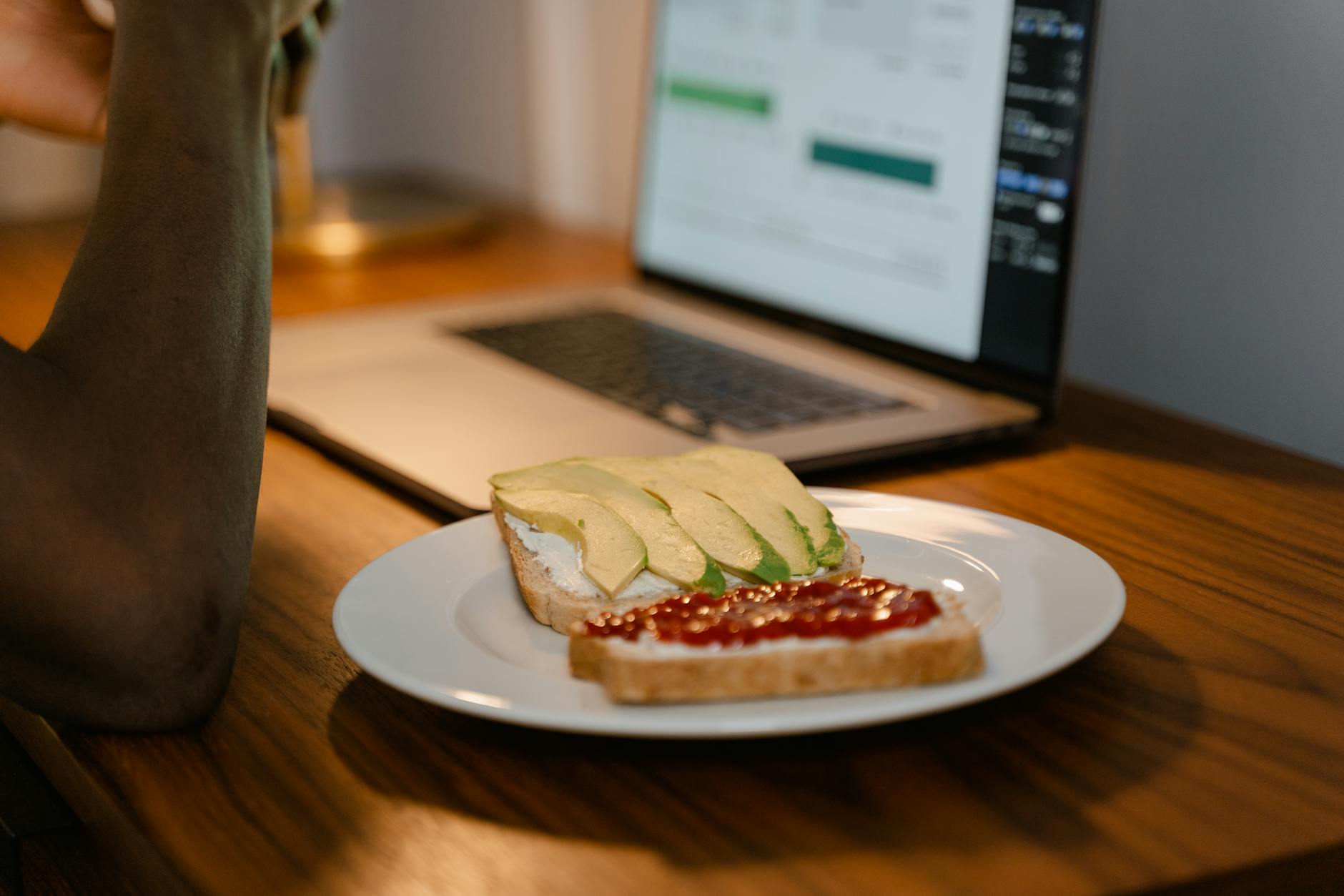 bread slices with avocado and ketchup on white plate